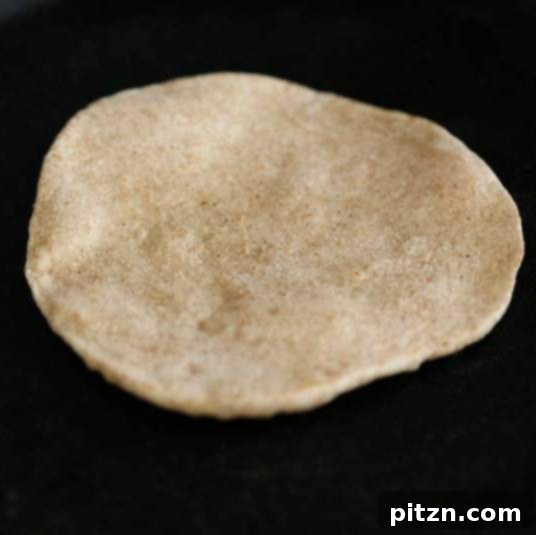 Easy Fluffy Vegan Pita Bread 3 Flipping Vegan Pita Bread on a Hot Skillet
