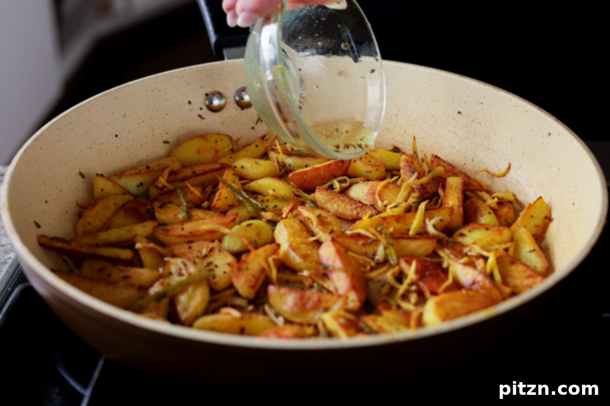 adding vinegar to Nepali aloo