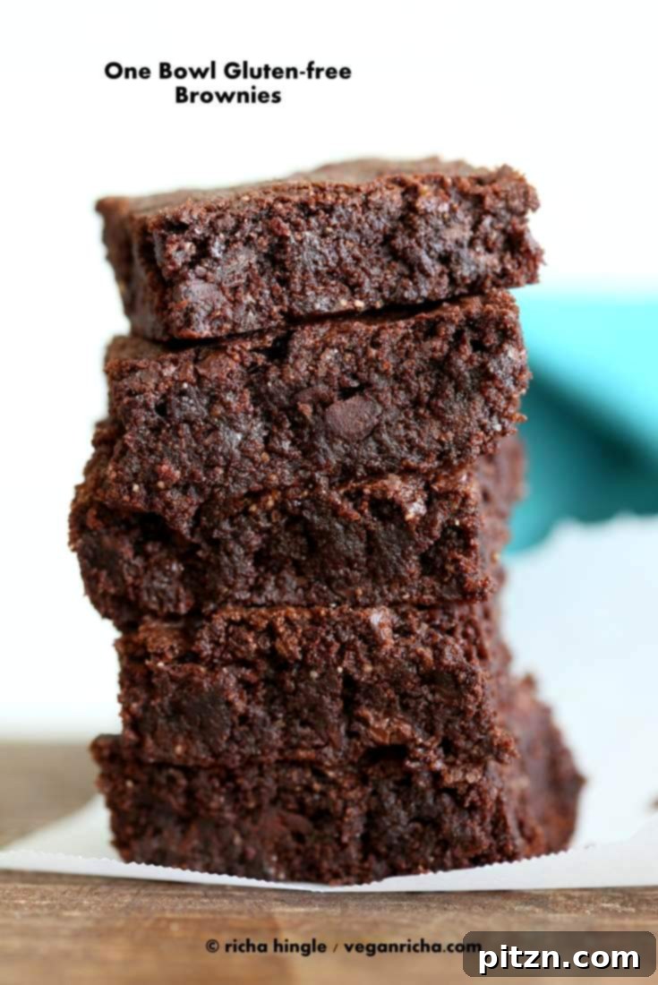 Decadent Vegan Gluten Free Brownies Made Easy 2 Delicious Gluten-Free Vegan Brownies in a pan, ready to be sliced, garnished with nuts.