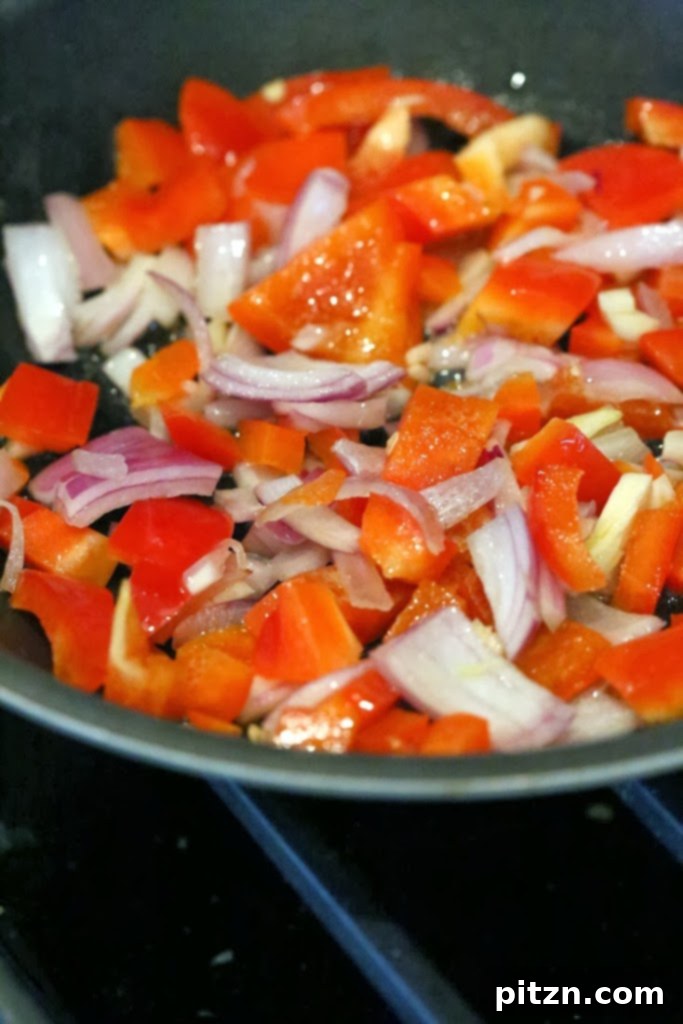 Sautéing onions, peppers, and garlic for the scramble