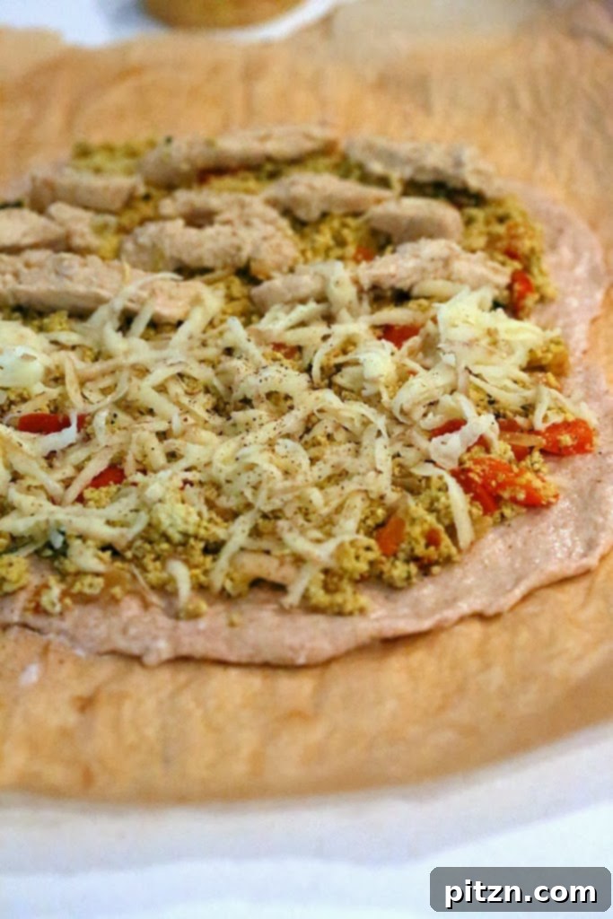 Pizza with scramble and grated potato topping, ready for baking