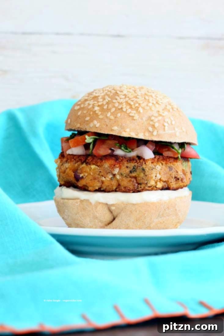The Tri-Veggie Power Burger 7 A plate of two Pinto Bean Broccoli Lentil Burgers with fresh cilantro garnish | Vegan Richa