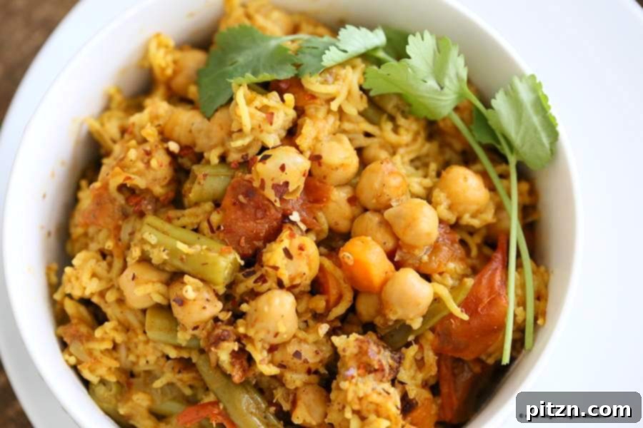 One-Pot Curried Chickpea Rice Pilaf 3 Close-up of fluffy Chickpea Rice Pulao, highlighting its vibrant colors and textures. Vegan Richa.