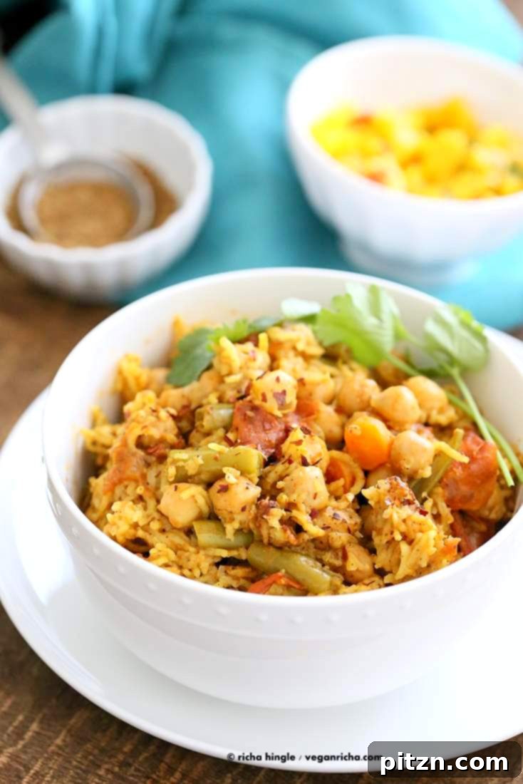One-Pot Curried Chickpea Rice Pilaf 4 A vibrant bowl of Chickpea Rice Pulao, garnished with fresh herbs, showcasing its appetizing appeal. Vegan Richa.