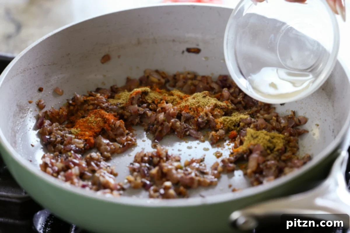 Adding lemon juice to the spice and onion mixture