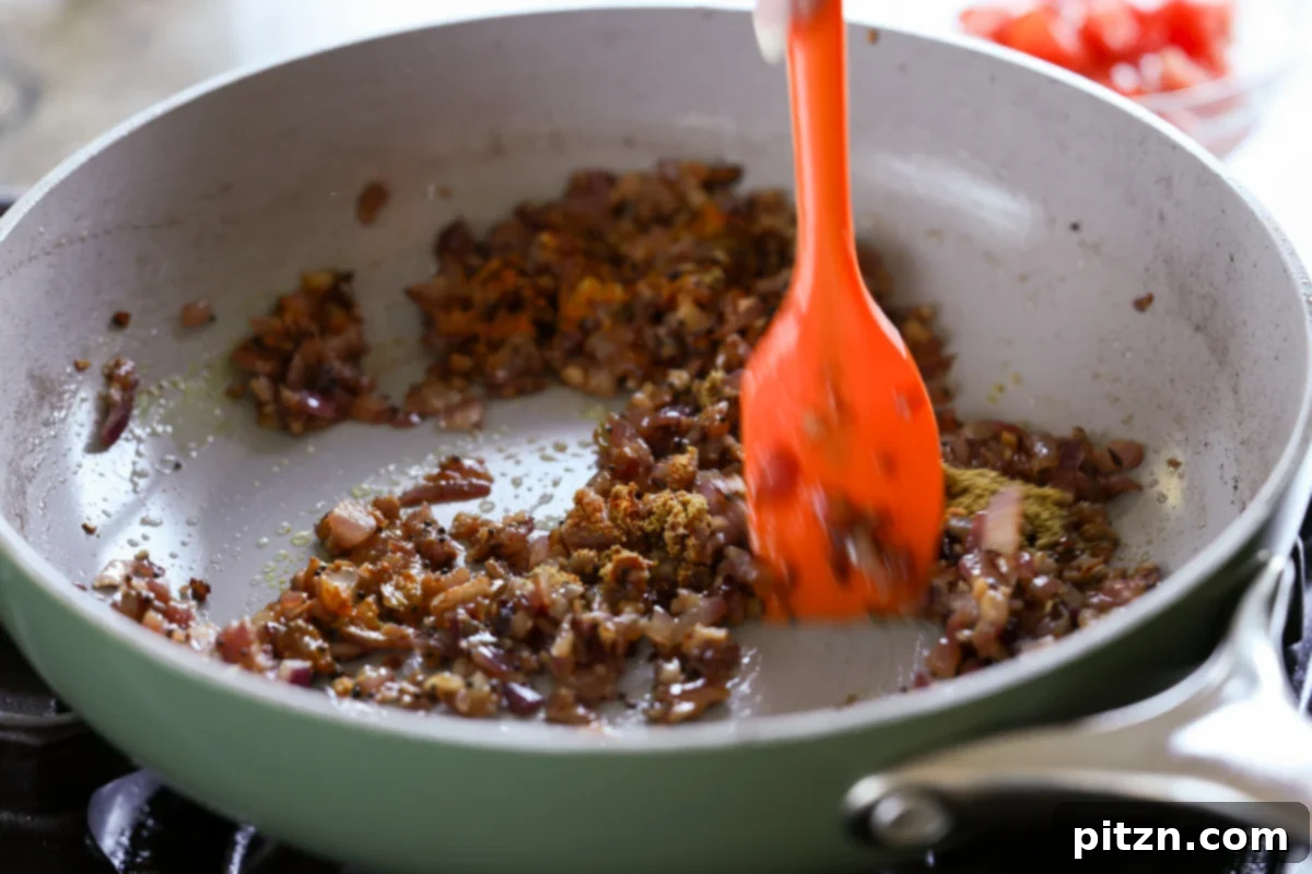 Mixing the onions and spices in the pan