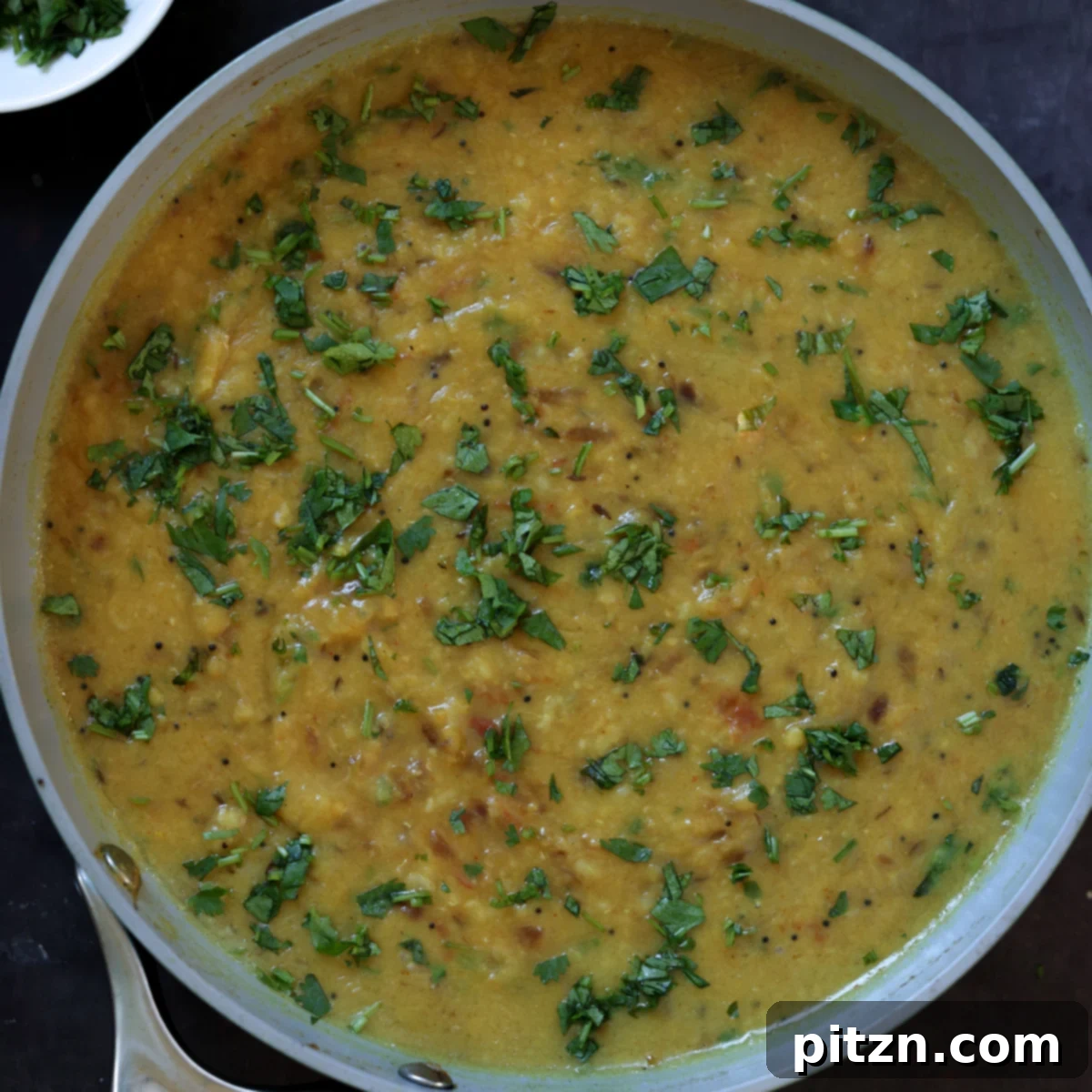 Finished Dal Fry simmering gently in a large pan, ready to be served