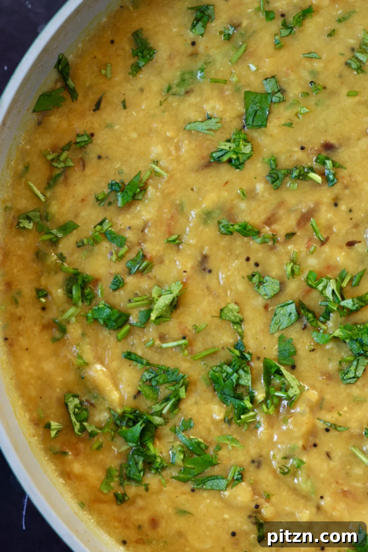 Close-up of Dal Fry in a pan, richly spiced and topped with fresh cilantro