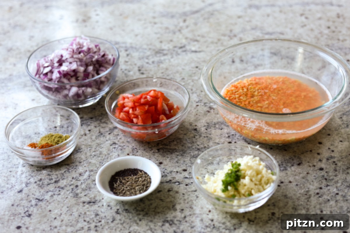 Ingredients for Dal Fry laid out in bowls on a kitchen counter, ready for preparation