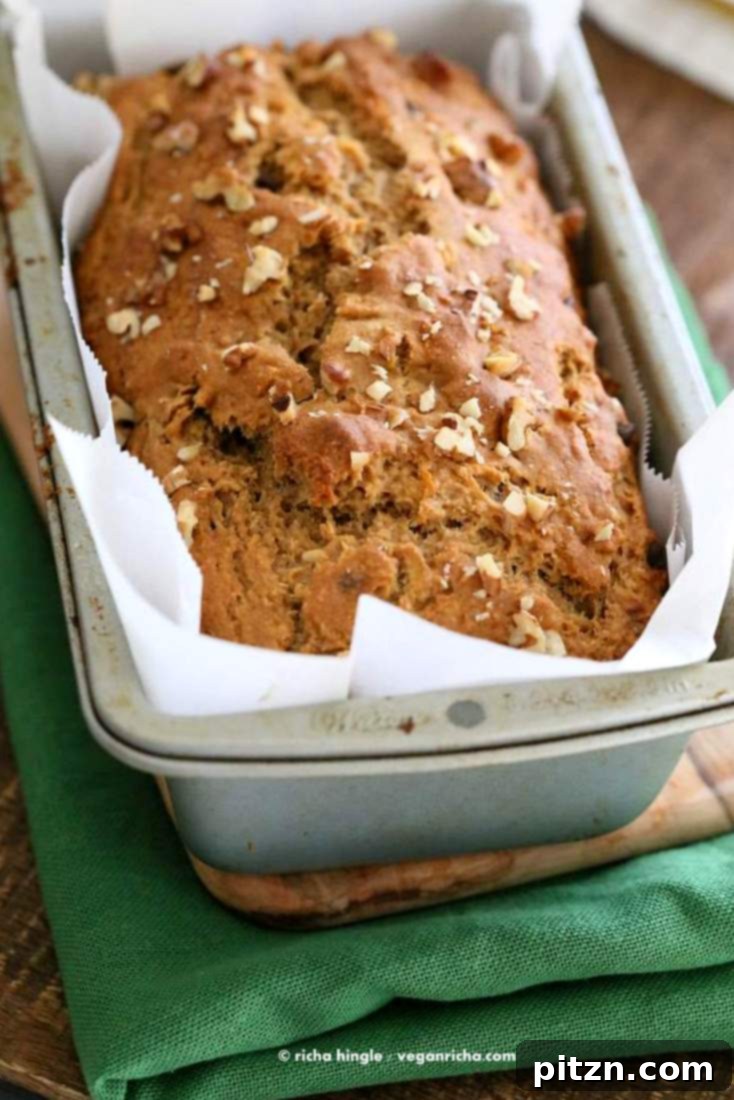 Delicious One-Bowl Vegan Banana Apple Loaf 8 A freshly baked One Bowl Vegan Banana Apple Bread, cooling on a rack before being sliced. Moist, healthy, and plant-based for breakfast or snack.