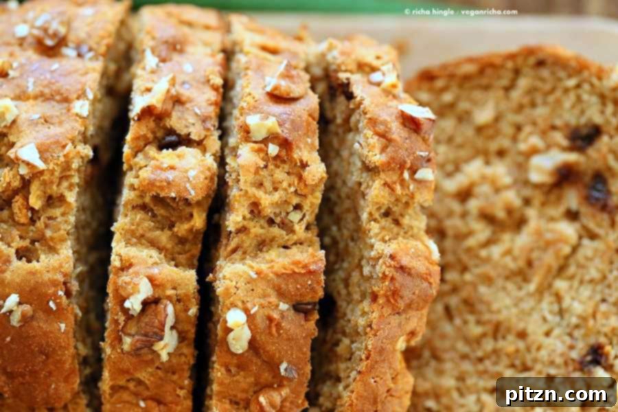 Delicious One-Bowl Vegan Banana Apple Loaf 9 Sliced One Bowl Vegan Banana Apple Bread, showing its moist texture and delicious inclusions. A healthy, oil-free, plant-based breakfast or snack.