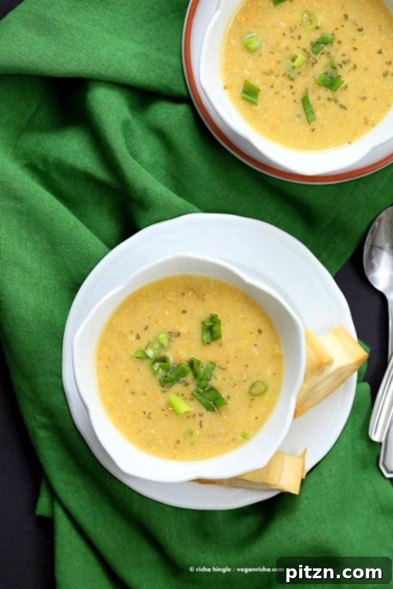 Vegan Chipotle Corn Chowder: A Cook The Pantry Book Review 5 A bowl of hot Vegan Chipotle Corn Chowder, a sweet and spicy plant-based soup with pimientos and parsley garnish, demonstrating a delicious recipe from Cook the Pantry.