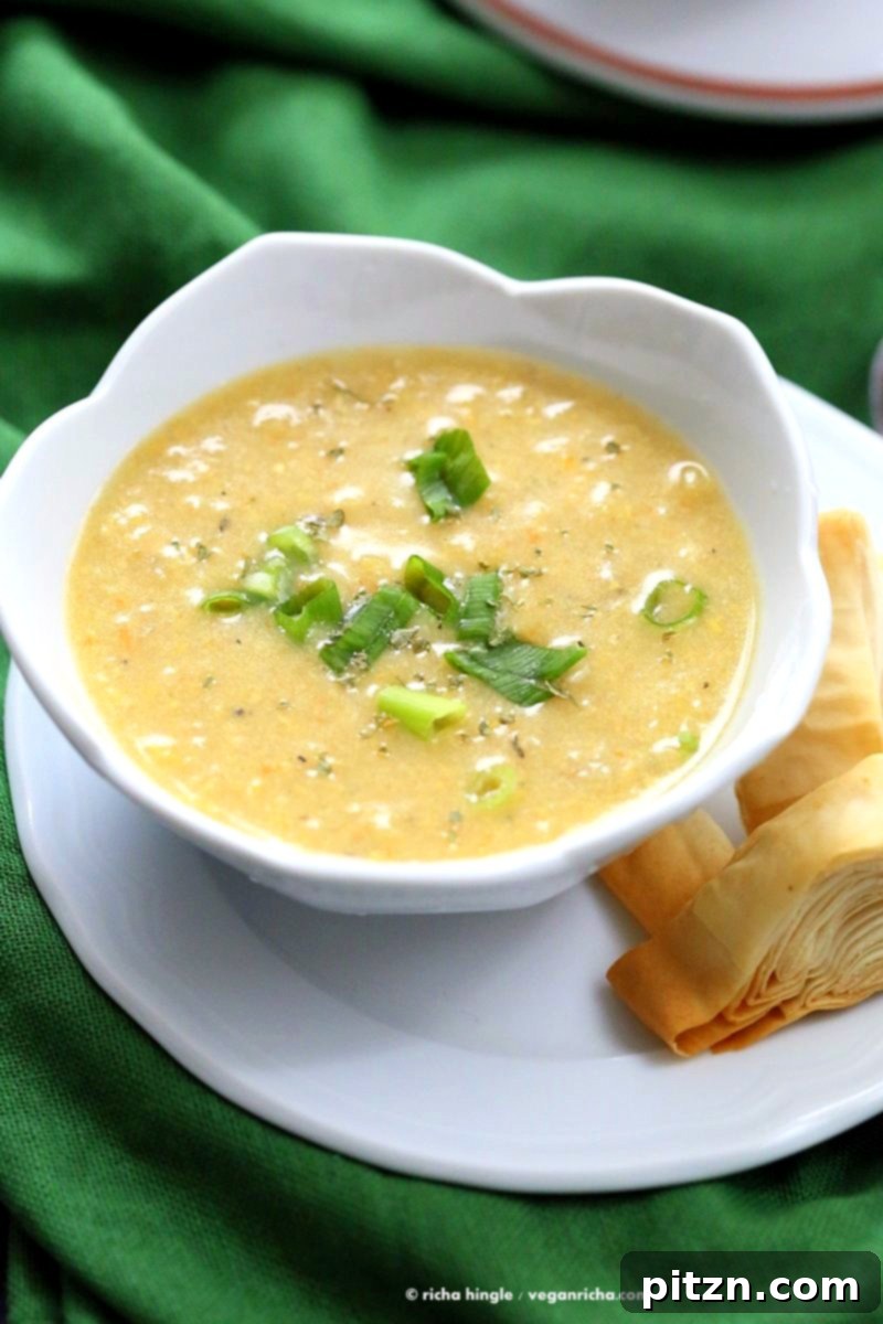 Vegan Chipotle Corn Chowder: A Cook The Pantry Book Review 7 A vibrant close-up of Vegan Chipotle Corn Chowder, highlighting the sweet and spicy flavors and colorful pimiento and parsley garnish from Cook the Pantry.