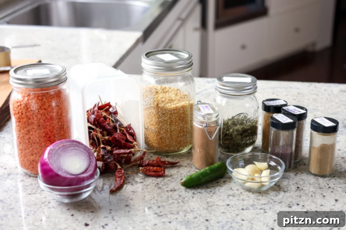 Dal Tadka Lentil Soup Mix in a Jar 10 Various dal in a jar ingredients laid out on a kitchen counter, ready for assembly.