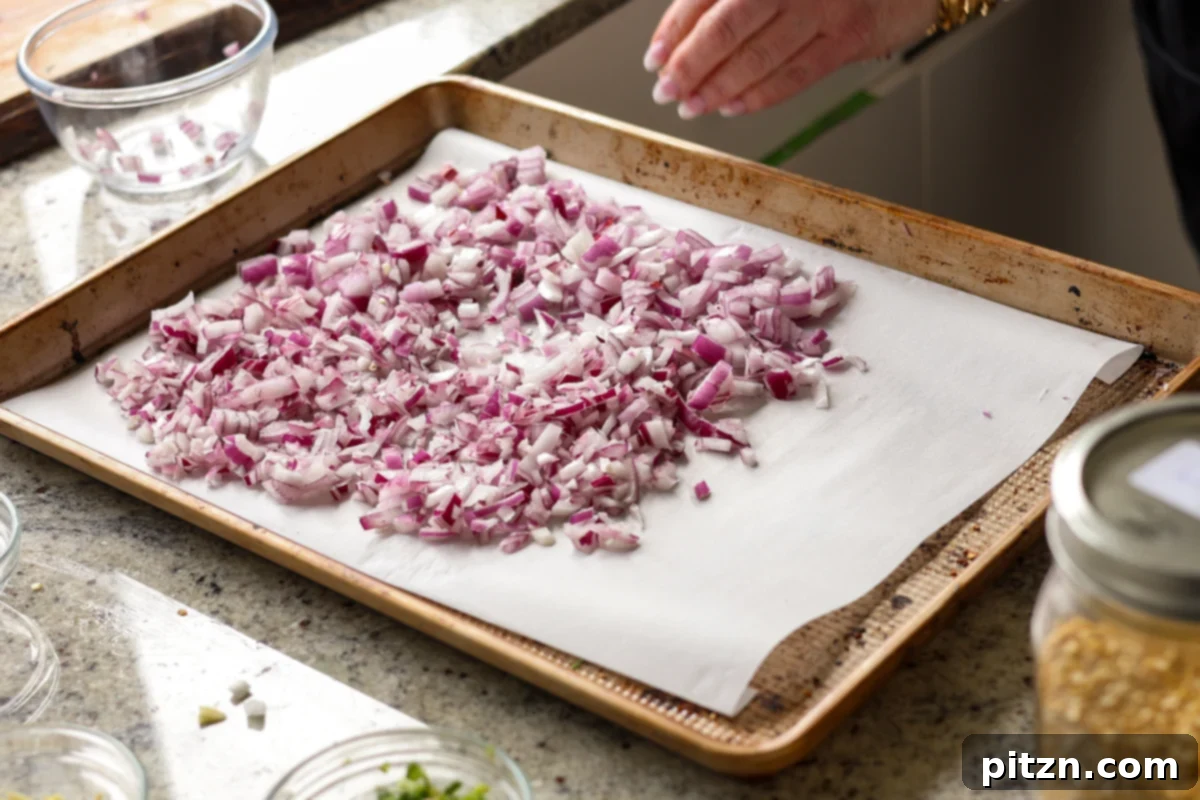 Dal Tadka Lentil Soup Mix in a Jar 14 Spreading chopped onion evenly onto a parchment-lined baking sheet.