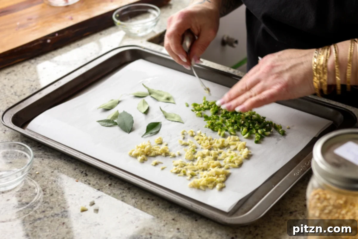 Dal Tadka Lentil Soup Mix in a Jar 15 Spreading curry leaves, garlic, and chili onto a baking sheet for drying.