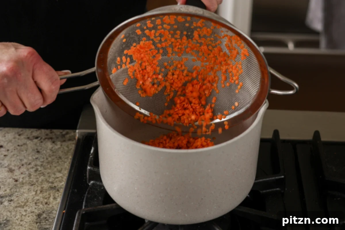 Dal Tadka Lentil Soup Mix in a Jar 24 Transferring thoroughly rinsed lentils from a colander to a cooking pan.
