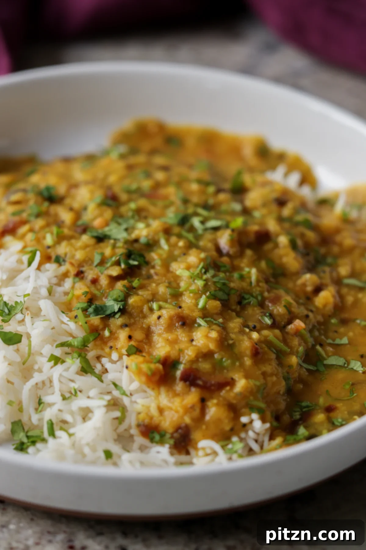 Dal Tadka Lentil Soup Mix in a Jar 7 Close-up of a bowl of creamy dal tadka served alongside fluffy white rice.