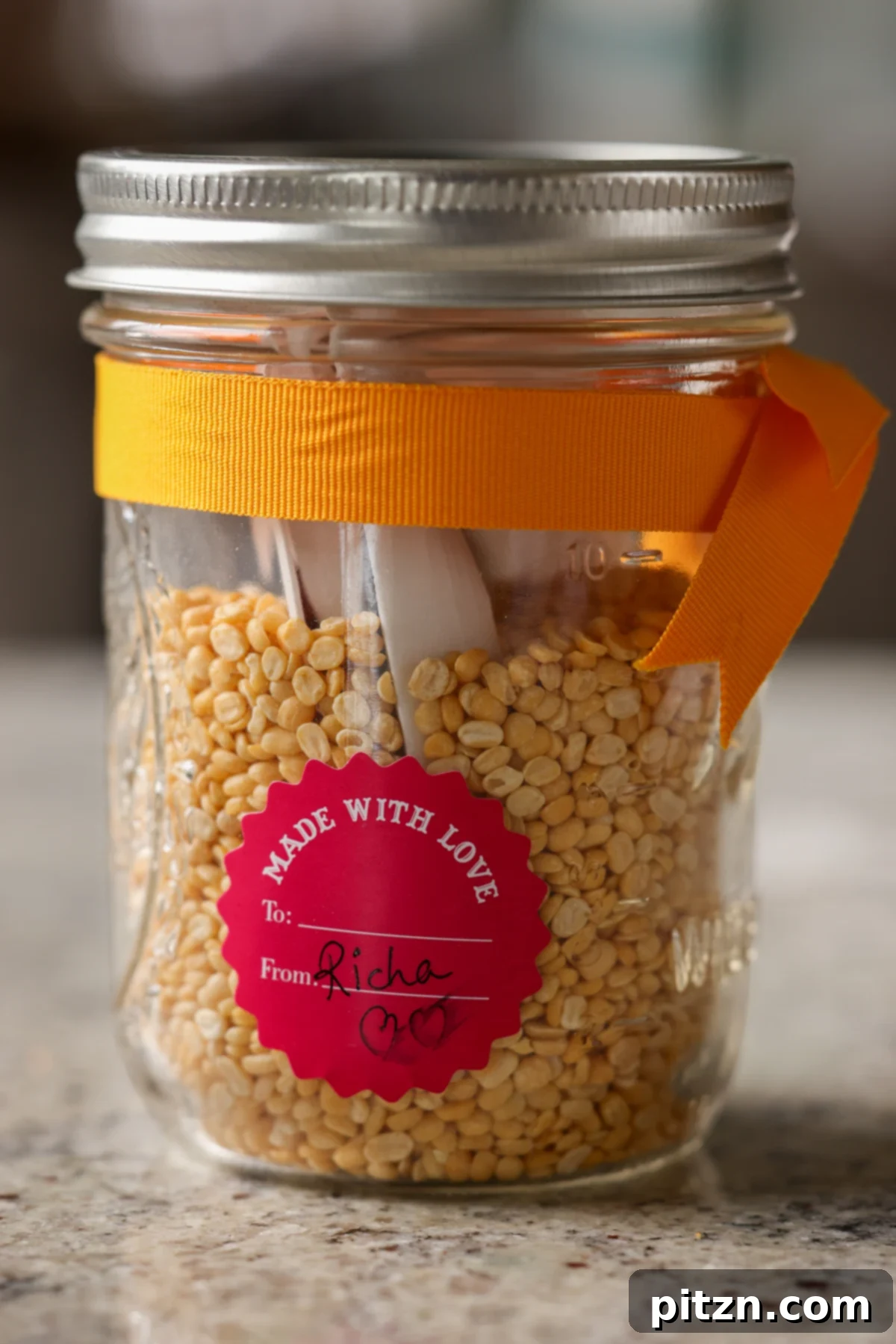 Dal Tadka Lentil Soup Mix in a Jar 8 Jar filled with split yellow lentil soup mix, displaying the layers of ingredients.