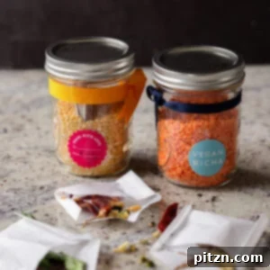 Dal Tadka Lentil Soup Mix in a Jar 9 Open jars of lentil soup mix with open spice pouches showcasing layered ingredients.