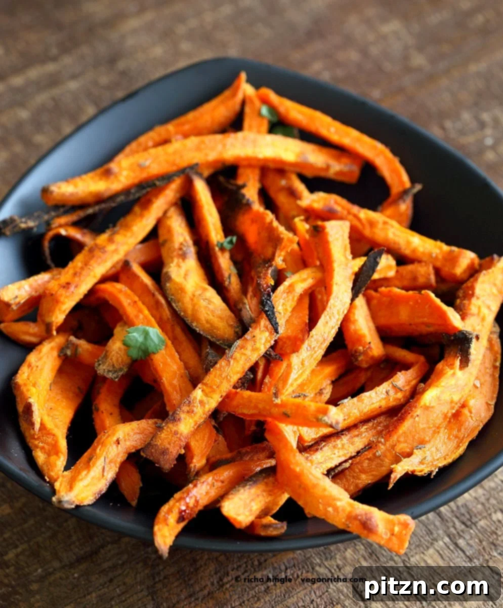 Close-up of baked sweet potato fries with spices, ready for the oven. Vegan, gluten-free, soy-free appetizer.