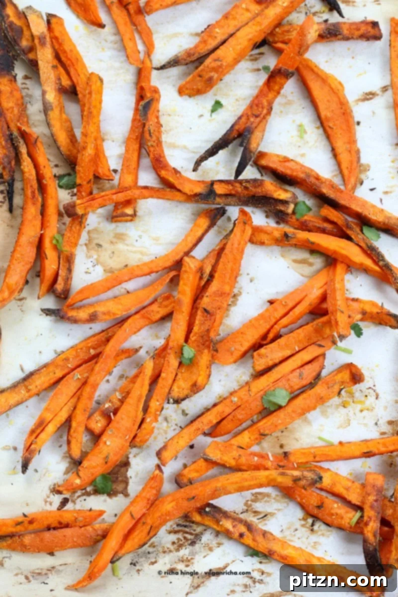 Sweet Potato Fries coated in starch and spices on a baking sheet, ready to bake. VeganRicha.com