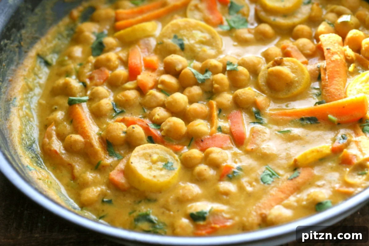 One-Pot Turmeric Peanut Butter Chickpea Curry 4 A top-down shot of Chickpeas in Turmeric Peanut Butter Curry, garnished with fresh cilantro and lime.