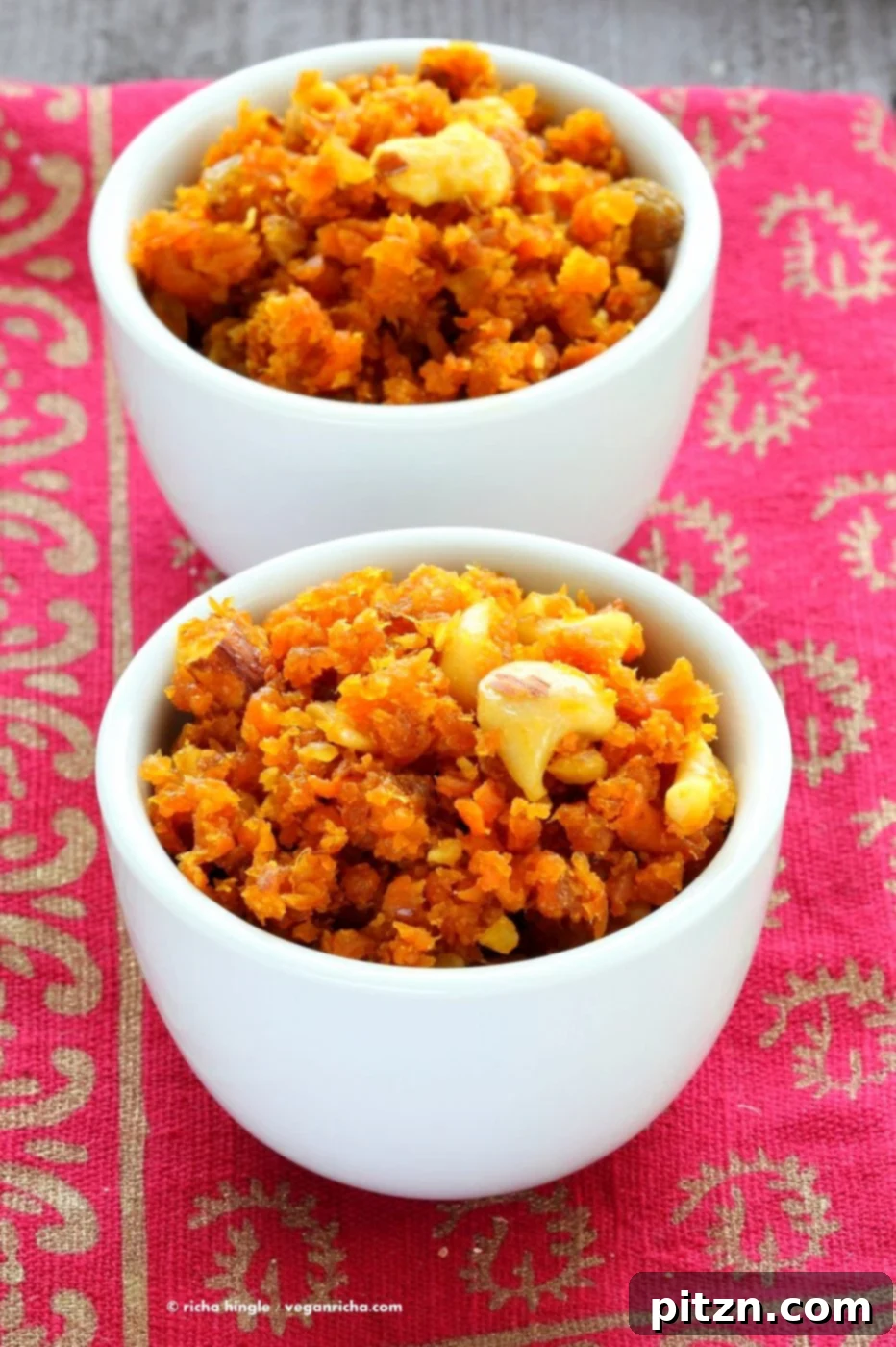 A vibrant platter of Vegan Carrot Halwa, also known as Gajar Ka Halwa, garnished with finely chopped cashews, raisins, and pistachios, ready to be enjoyed as a wholesome, plant-based Indian sweet. This recipe is gluten-free, soy-free, and full of flavor.