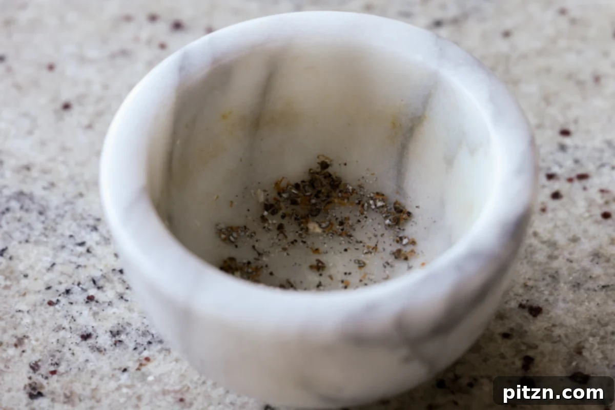 Toasted Cardamom Coconut Ladoo 7 Finely ground cardamom seeds in a traditional wooden mortar, ready to infuse their aroma into the ladoo.