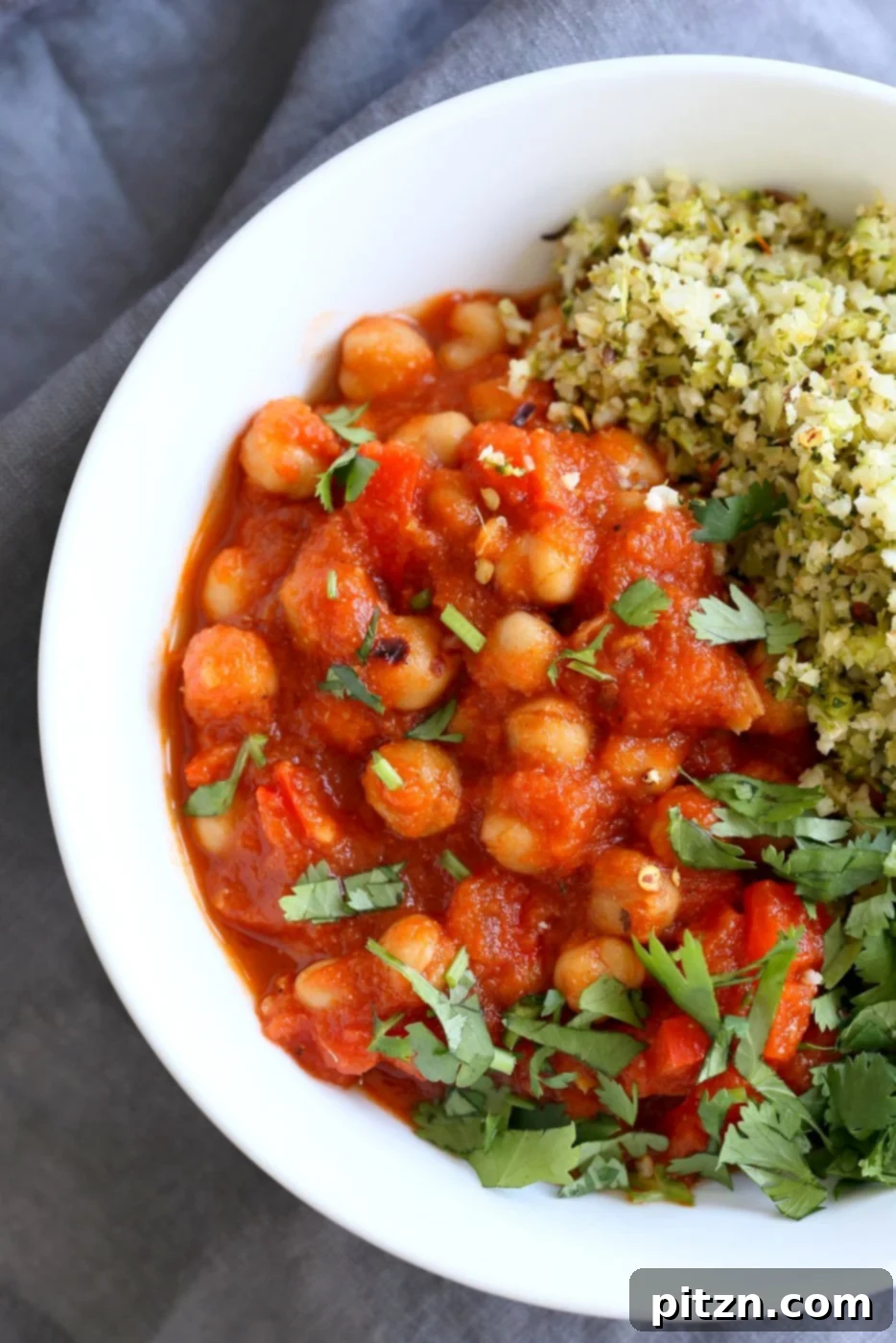Flavorful Spanish Chickpea Stew with Cumin scented Cauliflower Broccoli Rice. Smoky tomatoey Chickpea Stew can be served over rice or grains or cauliflower or broccoli rice. Vegan Gluten-free Nut-free Grain-free Soy-free Recipe | VeganRicha.com