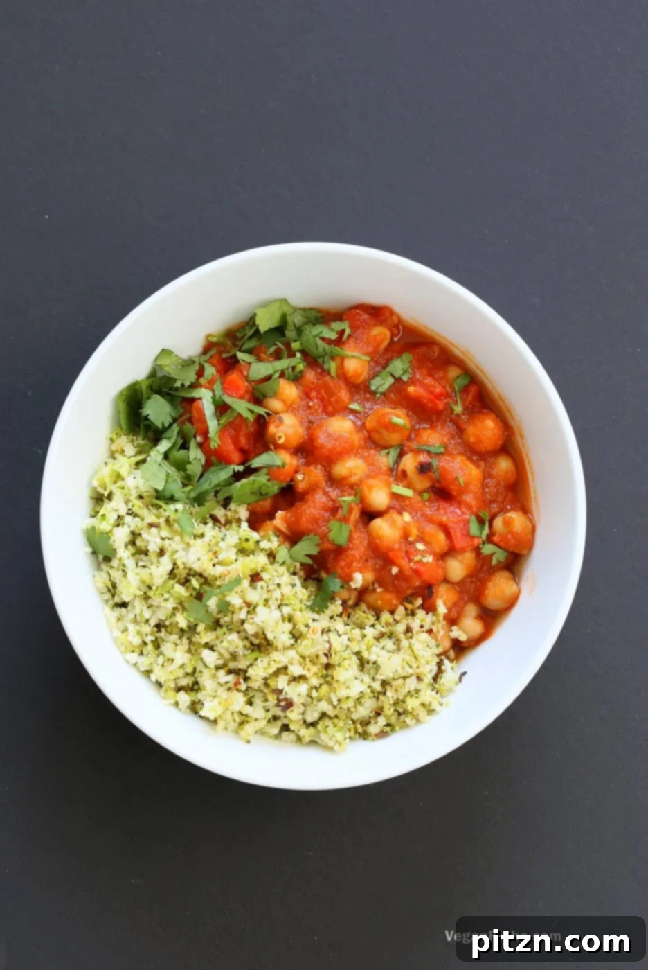 Flavorful Spanish Chickpea Stew with Cumin scented Cauliflower Broccoli Rice. Smoky tomatoey Chickpea Stew can be served over rice or grains or cauliflower or broccoli rice. Vegan Gluten-free Nut-free Grain-free Soy-free Recipe | VeganRicha.com