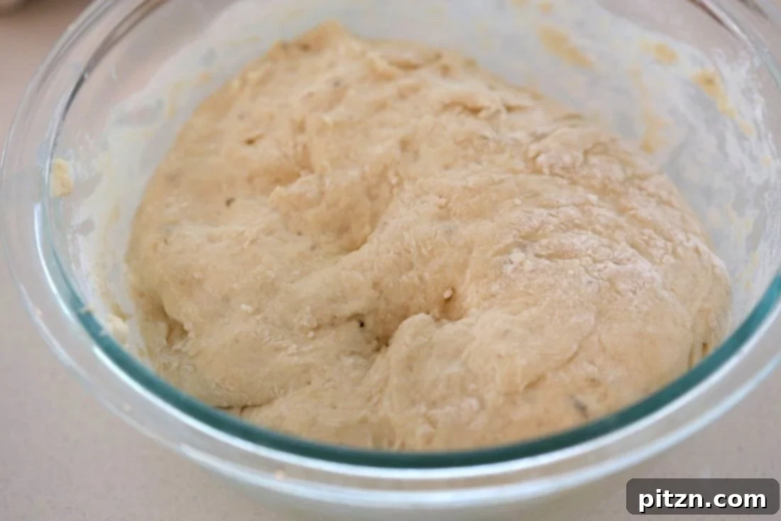 Cheesy Pizza Monkey Bread 5 Freshly prepared pizza dough resting in a bowl, ready to be shaped for Cheesy Pull Apart Pizza Bread. The first step in creating this delightful vegan, soy-free dish.