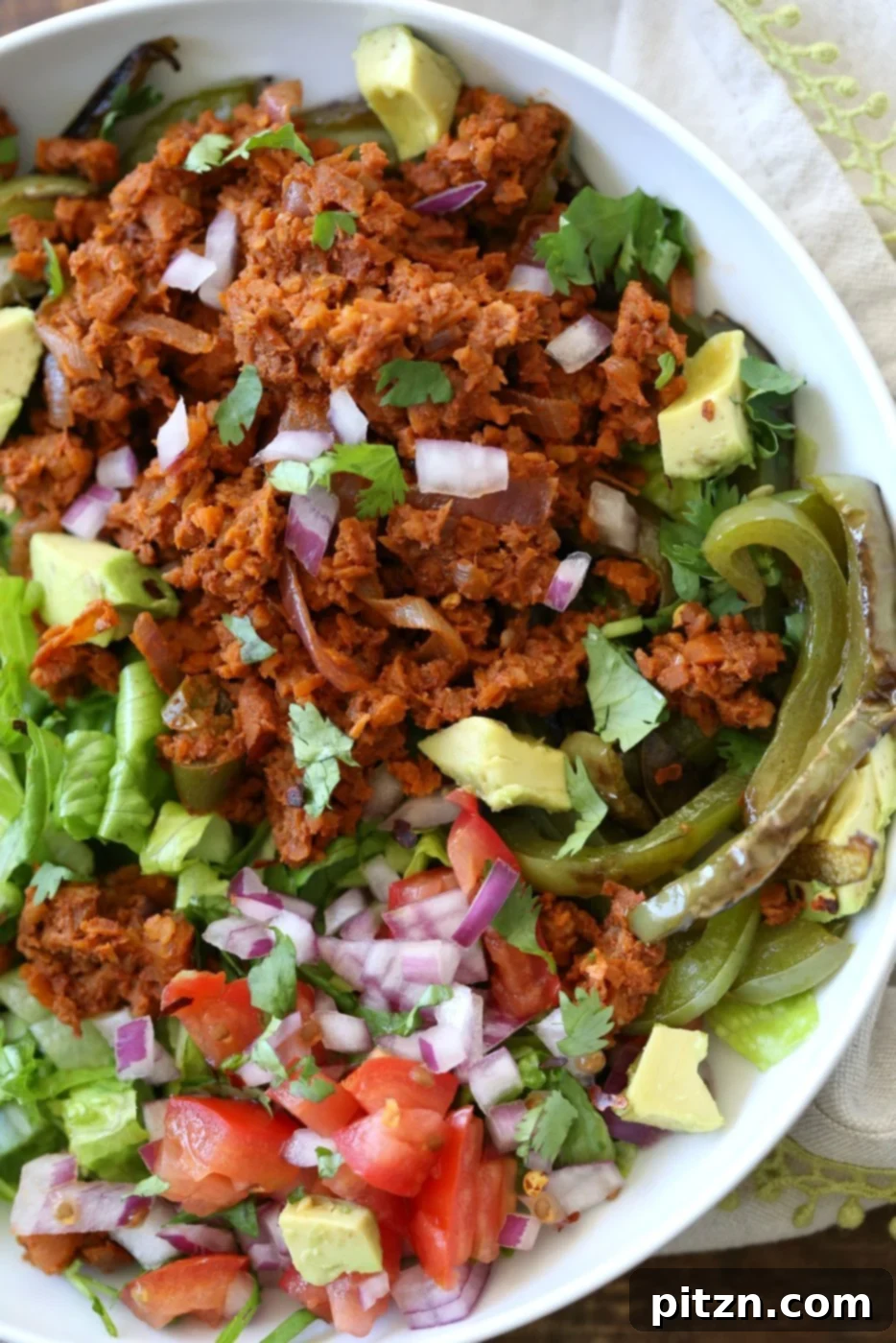 Hearty Vegan Taco Salad Bowl with Carrot-Walnut Crumbles 8 Close-up of the fully assembled vegan taco salad bowl, showcasing the textures and vibrant colors of all the ingredients.