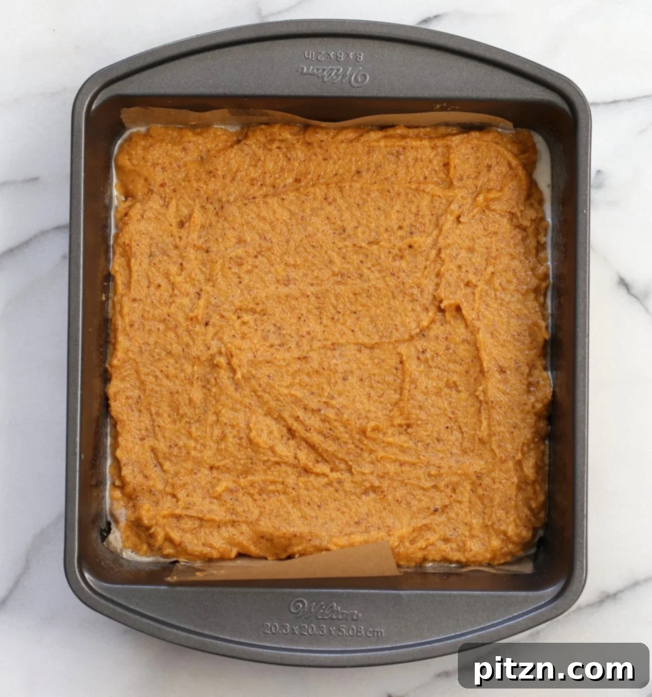 Vegan Gluten-Free Sweet Potato Pecan Crumb Cake 6 Spreading crumb topping over sweet potato cake batter in a parchment-lined pan