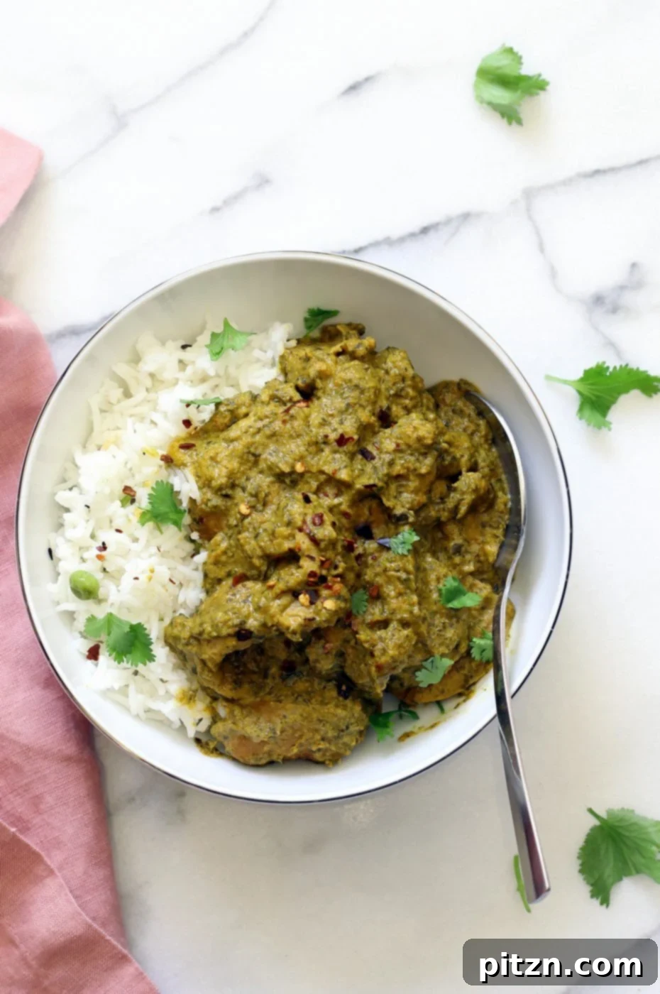 Instant Pot Vegan Chicken Saag with Soy Curls. A close-up of the textured soy curls in the vibrant green spinach sauce. Vegan, Gluten-free, One-Pot. #Vegan #Glutenfree #Recipe