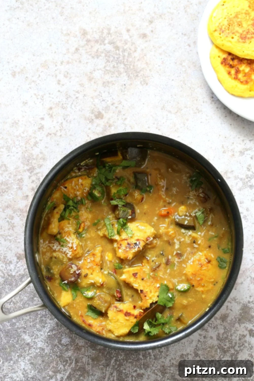Traditional Bengali Chapor Ghonto, lentil fritters in a flavorful vegetable and coconut stew.