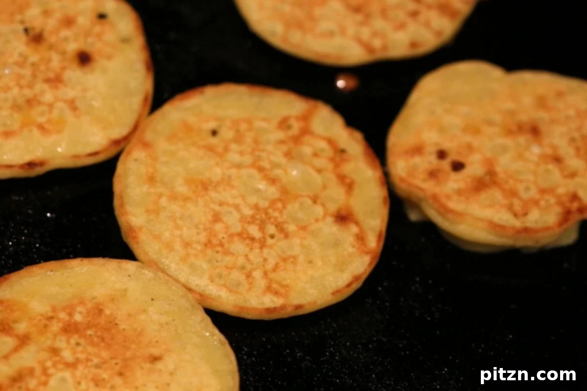 Pan-frying the Moong Dal fritters for Chapor Ghonto.