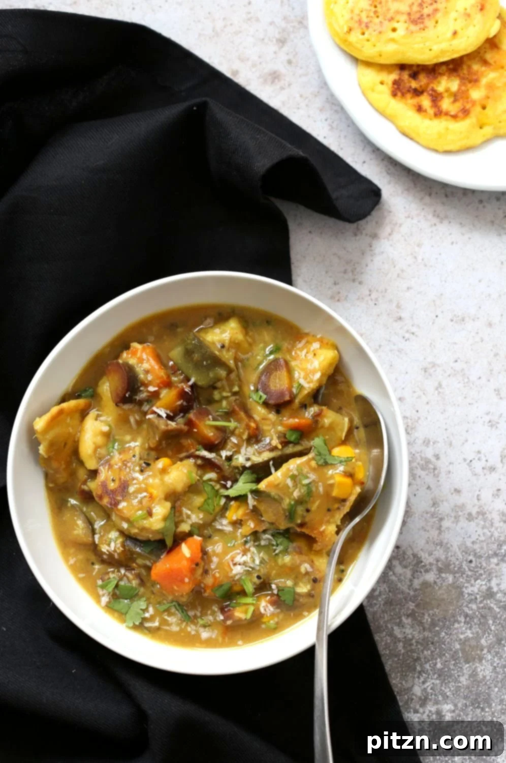 Plated Bengali Chapor Ghonto with Lentil Fritters.
