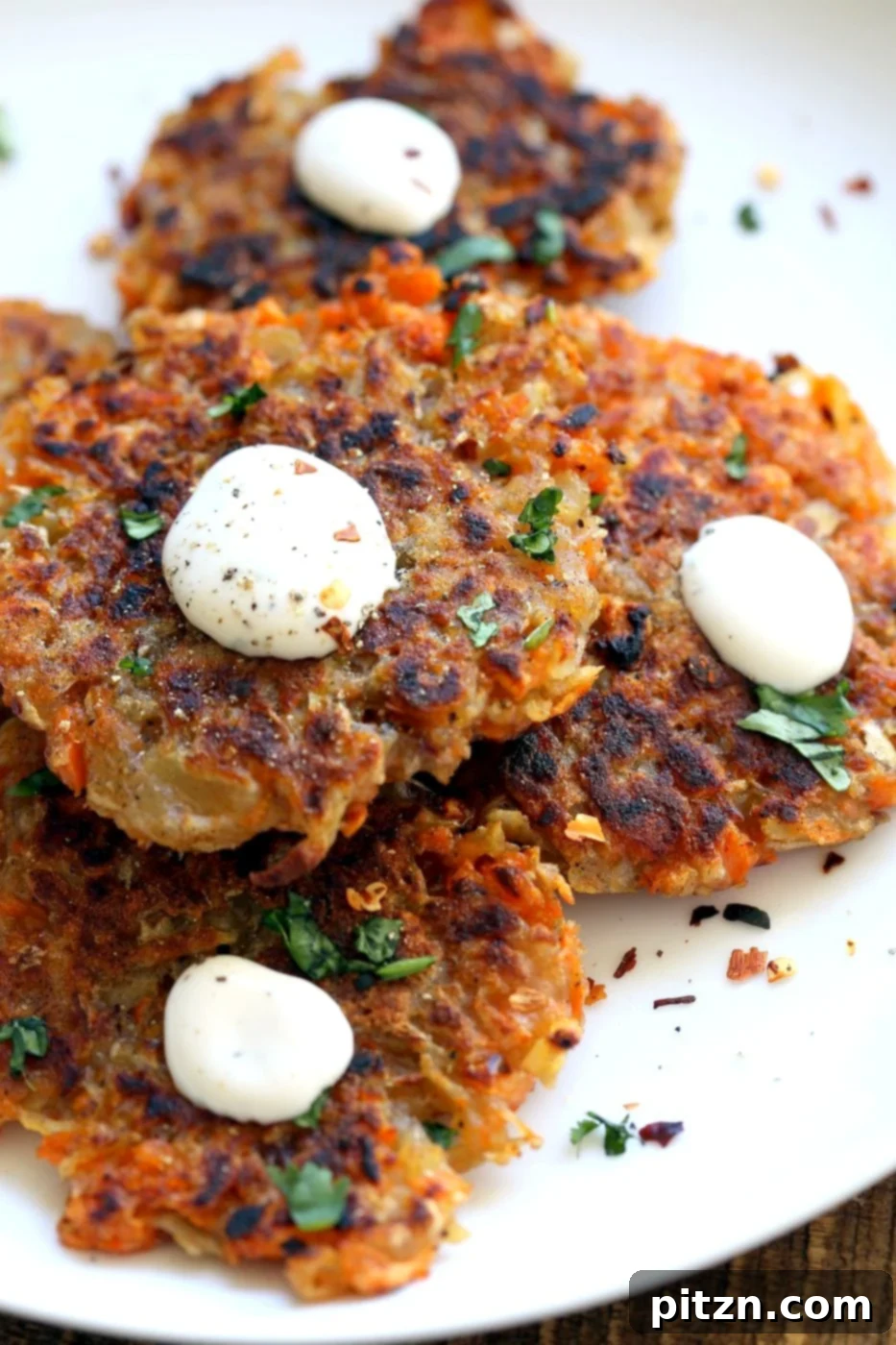 Platter of golden brown vegan potato and sweet potato latkes, ready to be served