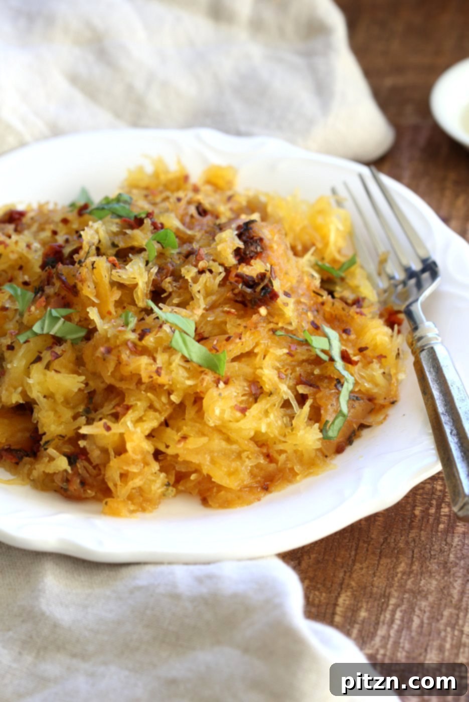 Beautifully plated Spaghetti Squash Pasta garnished with fresh basil, making for an appetizing light meal