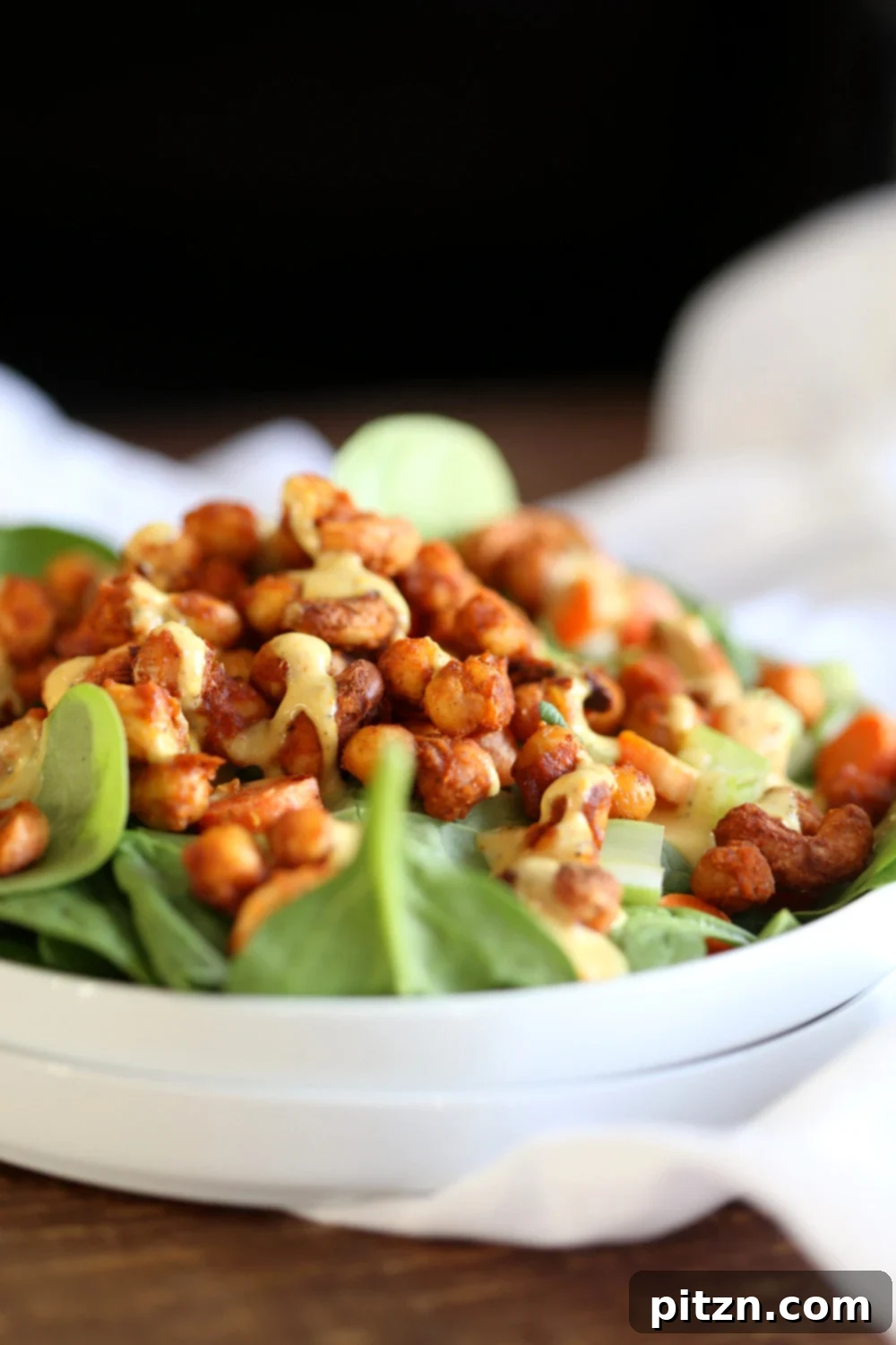 Spicy Sriracha Chickpea Cashew Spinach Power Bowl with Golden Curry 3 Delicious Sriracha Chickpea Spinach Bowl with Ranch dressing on a marble counter