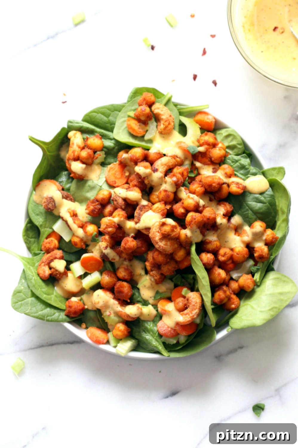 Spicy Sriracha Chickpea Cashew Spinach Power Bowl with Golden Curry 7 Finished Sriracha Chickpeas, Cashews, and Spinach Bowl with Ranch Curry Dressing, ready to serve