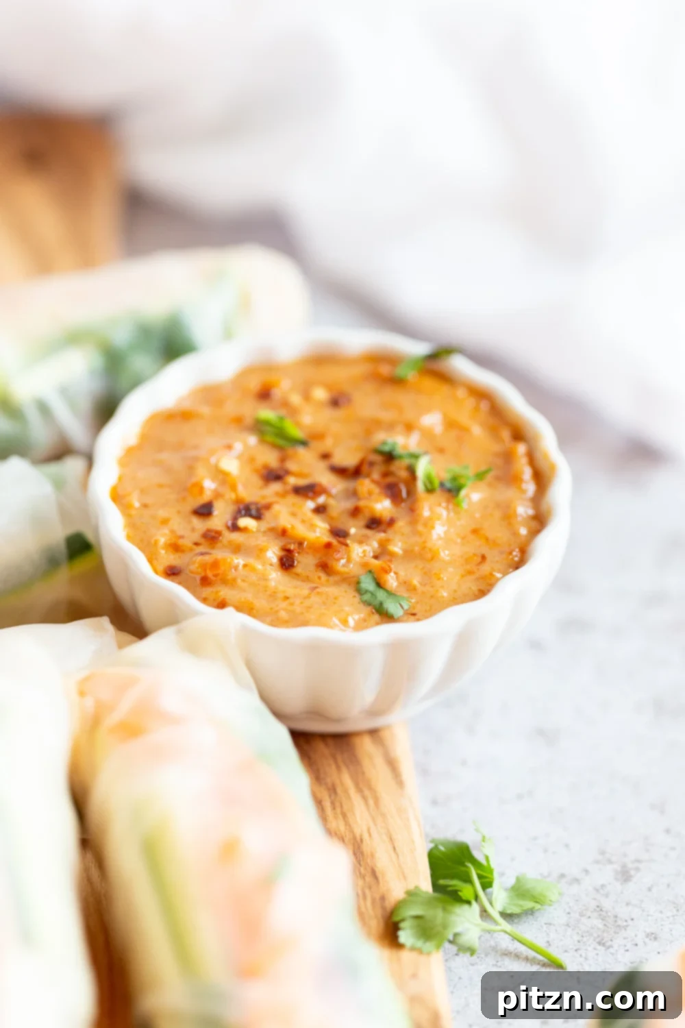 Close-up shot of vegan fresh spring rolls on a wooden board, showcasing their vibrant fillings.
