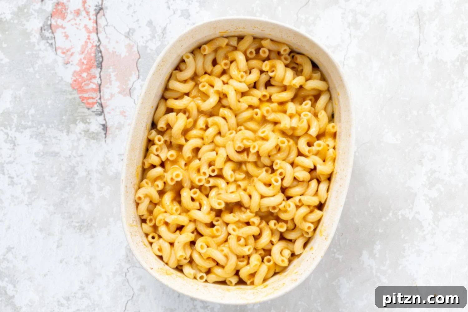 Side view of the baked pasta dish, highlighting the layers of creamy sauce and crunchy topping.