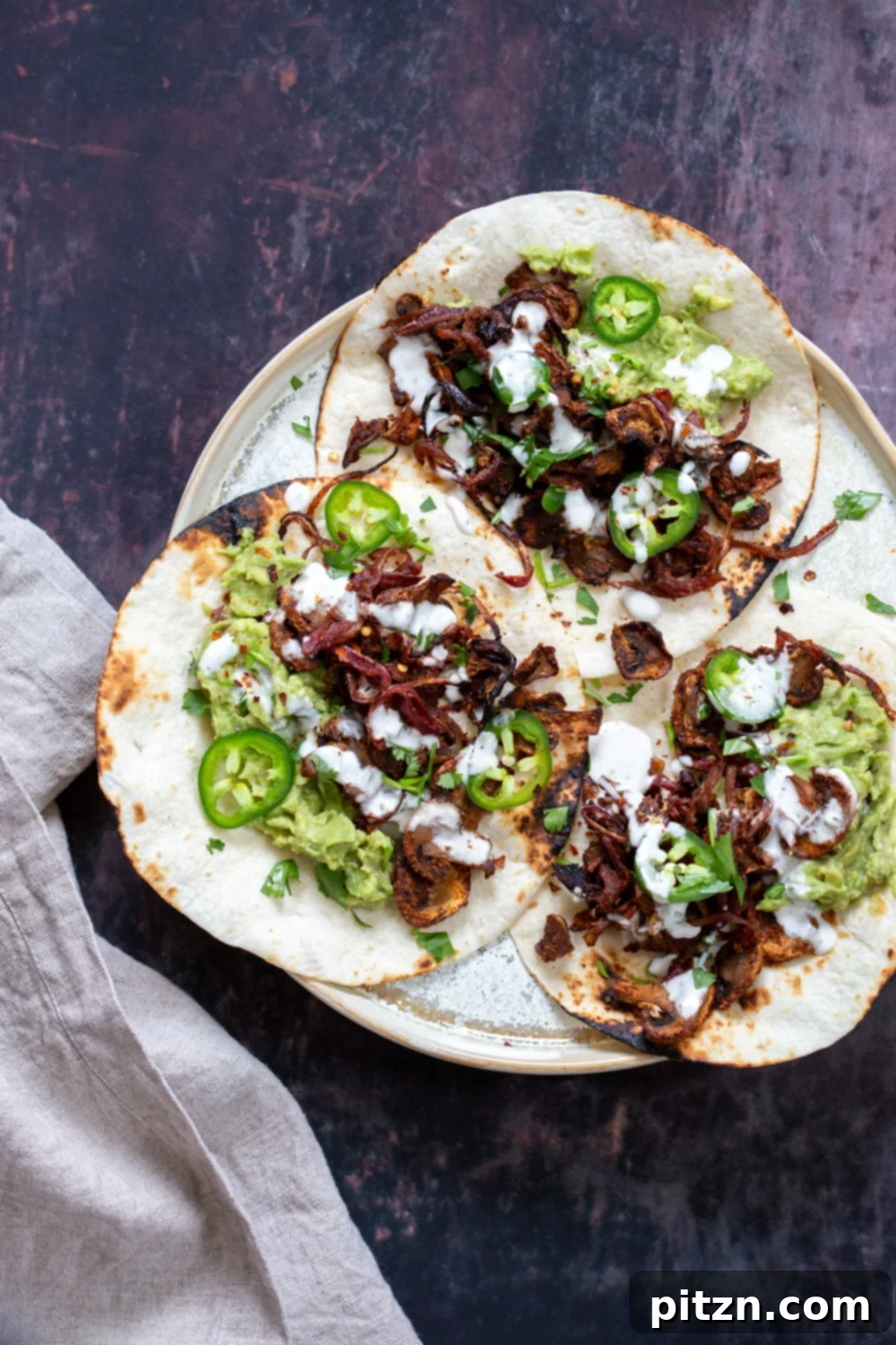 Delicious Vegan Carnitas made with mushrooms, marinated in a spicy, smoky, and zesty blend, baked and served with fresh toppings in tacos. A healthy and flavorful plant-based alternative to traditional carnitas.