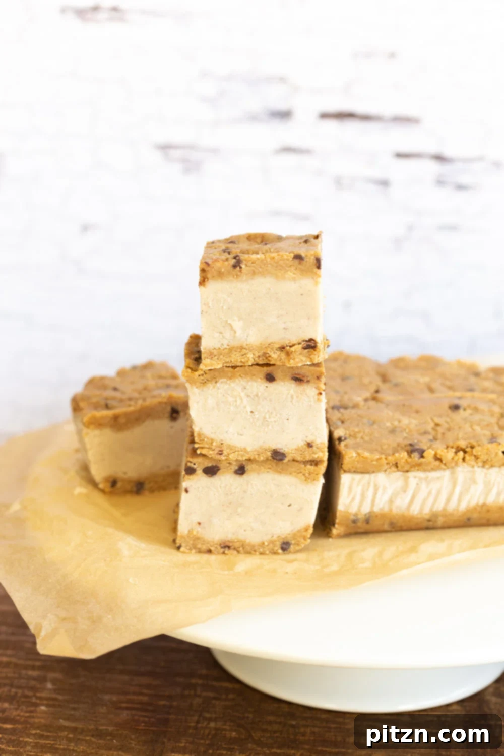 Vegan Cookie Dough Ice Cream Sandwiches stacked elegantly on a white cake stand