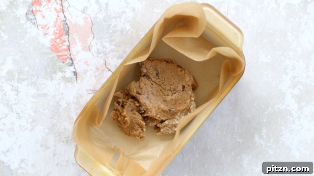 Cookie Dough in a parchment lined loaf pan for our Vegan Cookie Dough Ice Cream Sandwiches, ready for freezing