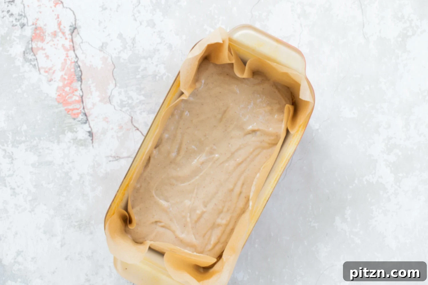 Ice cream layer being added to the baking pan for our Vegan Cookie Dough Ice Cream Sandwiches, creating a luscious filling