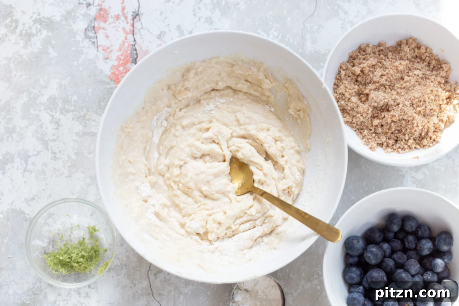 Batter for our Vegan Blueberry Muffins in a white bowl
