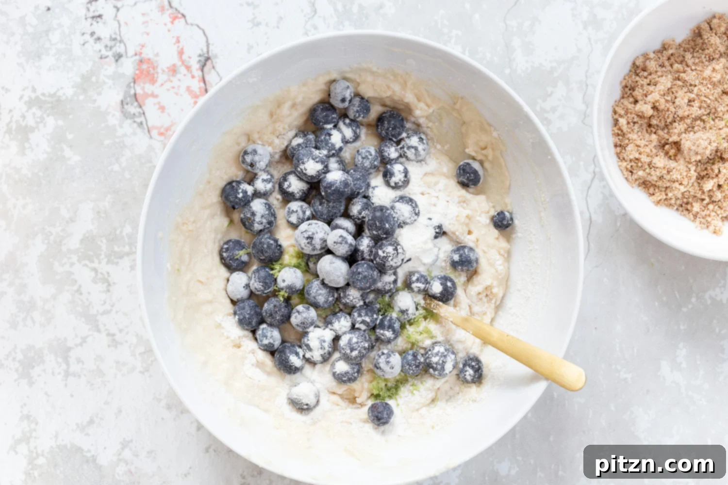 Batter for our Vegan Blueberry Muffins in a white bowl